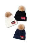 ABB852 - Cable knit beanie with Blessed plaid patch and faux fur pom
